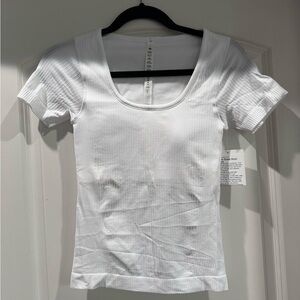 LULULEMON - never worn with tags (slight crop) ebb to street short sleeve.